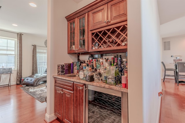 bar with visible vents, wine cooler, a bar, light wood-style floors, and recessed lighting