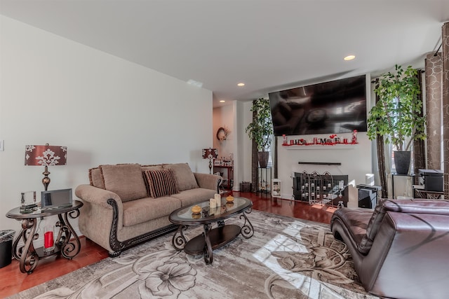 living room featuring a fireplace, wood finished floors, and recessed lighting