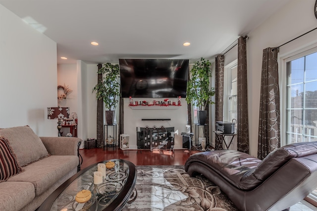 living area with recessed lighting, a fireplace, and wood finished floors