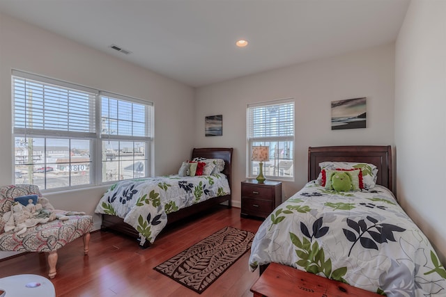 bedroom with baseboards, dark wood finished floors, visible vents, and recessed lighting