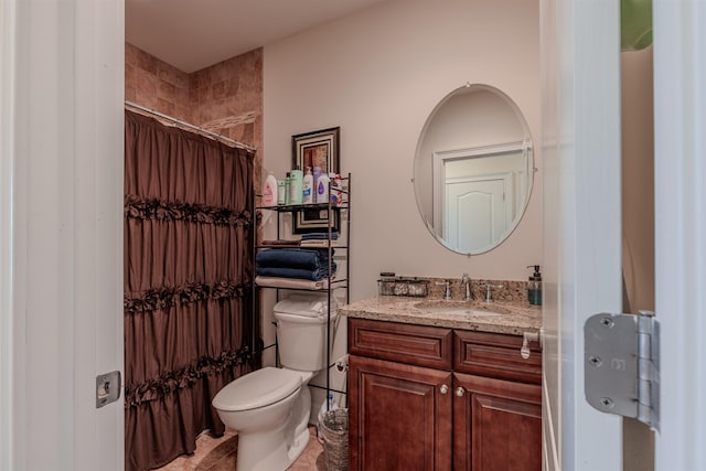 bathroom featuring a shower with shower curtain, vanity, and toilet