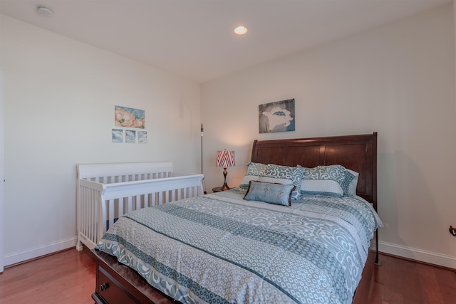 bedroom with recessed lighting, wood finished floors, and baseboards