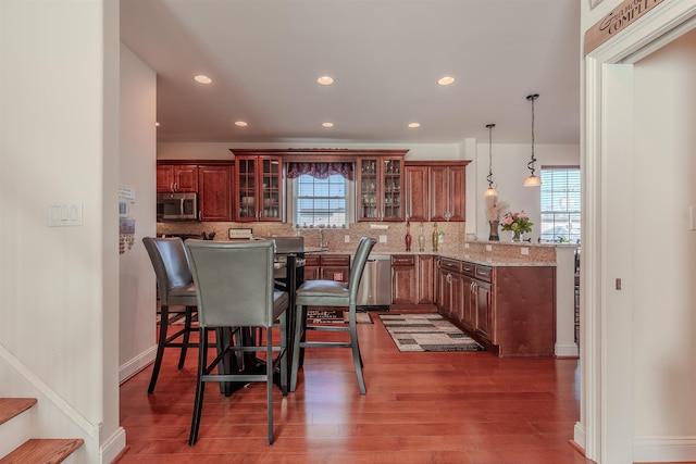 dining area with recessed lighting, dark wood finished floors, baseboards, and stairs