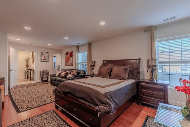 bedroom with light wood-style floors, visible vents, and recessed lighting