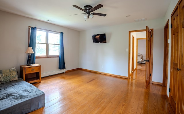 970 Shirley Ave, Erma, NJ 08204 - bedroom with a baseboard heating unit, light wood-style flooring, and a ceiling fan