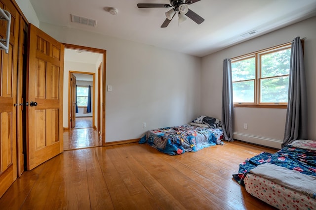 970 Shirley Ave, Erma, NJ 08204 - bedroom featuring baseboard heating, wood-type flooring, and a ceiling fan