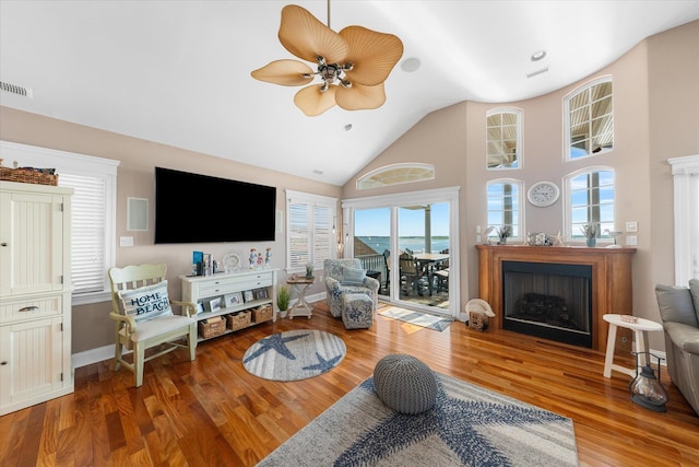 living room with hardwood / wood-style flooring, ceiling fan, and a healthy amount of sunlight