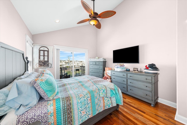 bedroom featuring access to exterior, hardwood / wood-style floors, high vaulted ceiling, and ceiling fan