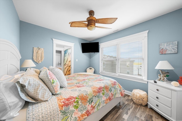 bedroom with ceiling fan and dark wood-type flooring