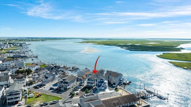 bird's eye view featuring a view of the beach and a water view