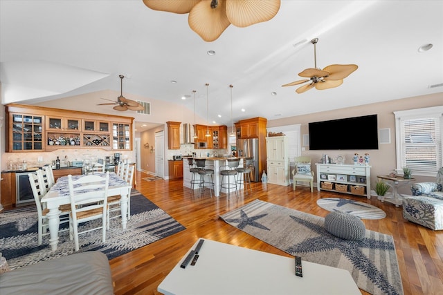 living room with hardwood / wood-style floors and vaulted ceiling