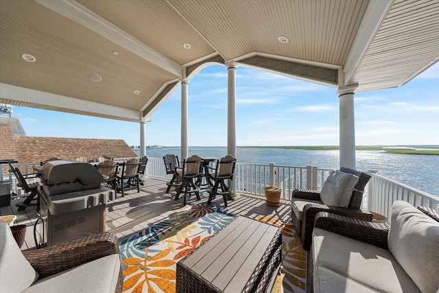 view of patio / terrace featuring a water view and a balcony