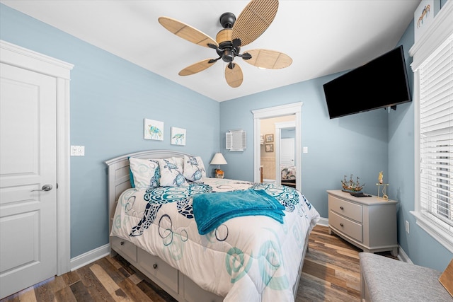 bedroom featuring ceiling fan, dark hardwood / wood-style floors, and multiple windows