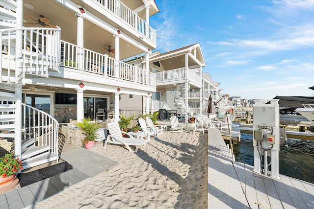 exterior space featuring a water view and a boat dock