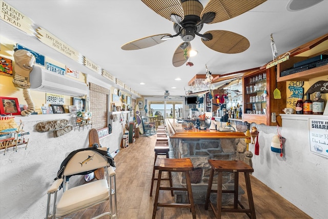 bar featuring hardwood / wood-style floors and ceiling fan