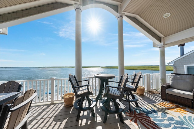 wooden deck featuring a water view