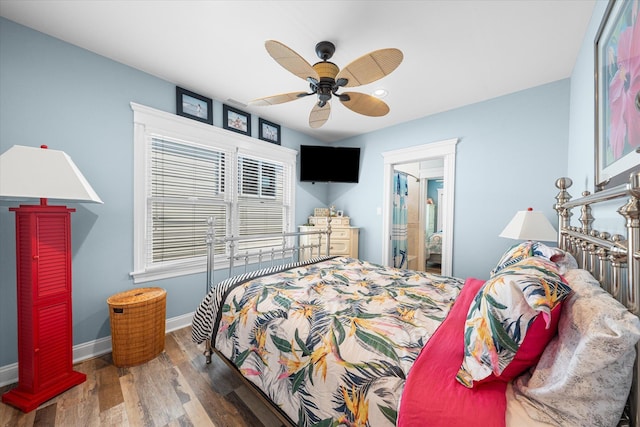 bedroom with ceiling fan, dark hardwood / wood-style floors, and ensuite bathroom