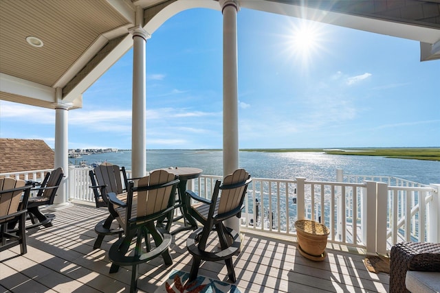 wooden deck featuring a water view