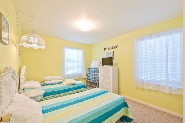 carpeted bedroom with baseboards