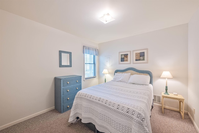 carpeted bedroom with baseboards