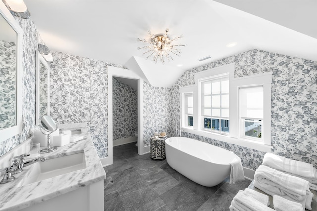 74 38th St, Avalon, NJ 08202 - full bathroom with wallpapered walls, double vanity, vaulted ceiling, and a freestanding tub