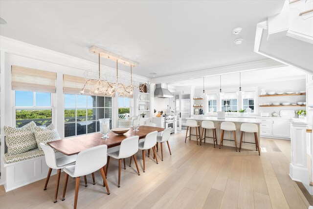 74 38th St, Avalon, NJ 08202 - dining space with ornamental molding, light wood-type flooring, and a chandelier