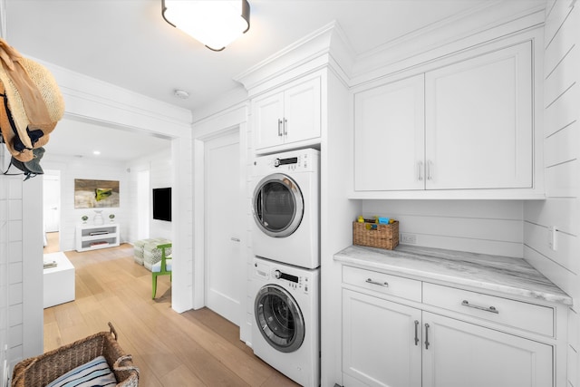 74 38th St, Avalon, NJ 08202 - washroom with stacked washing machine and dryer, cabinet space, light wood finished floors, and crown molding