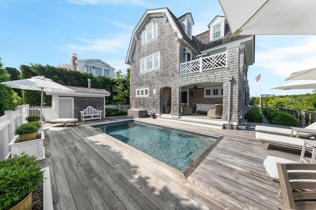 74 38th St, Avalon, NJ 08202 - rear view of property featuring a wooden deck, an outdoor hangout area, and an outbuilding