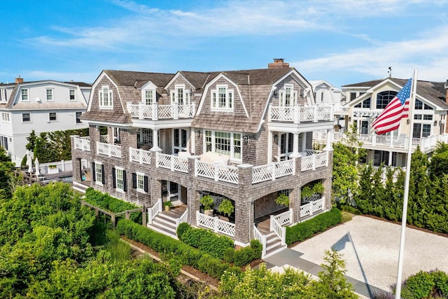 74 38th St, Avalon, NJ 08202 - rear view of house featuring a gambrel roof, a balcony, and a chimney