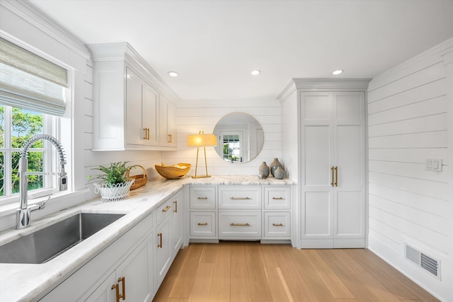 74 38th St, Avalon, NJ 08202 - kitchen with light wood-style flooring, recessed lighting, white cabinets, light stone countertops, and wooden walls