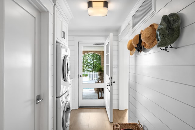 74 38th St, Avalon, NJ 08202 - laundry area with stacked washer / dryer, light wood-style flooring, and cabinet space