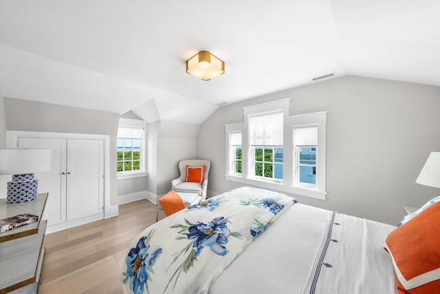 74 38th St, Avalon, NJ 08202 - bedroom with light wood-type flooring, vaulted ceiling, and a closet