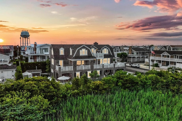 74 38th St, Avalon, NJ 08202 - back of house at dusk featuring a residential view and a chimney