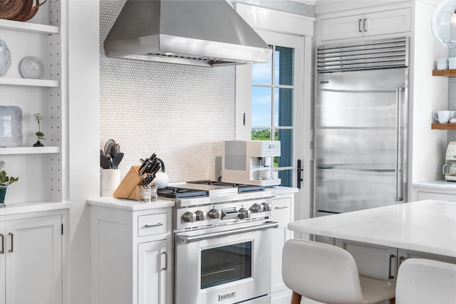 74 38th St, Avalon, NJ 08202 - kitchen featuring wall chimney range hood, high end appliances, open shelves, light countertops, and white cabinetry