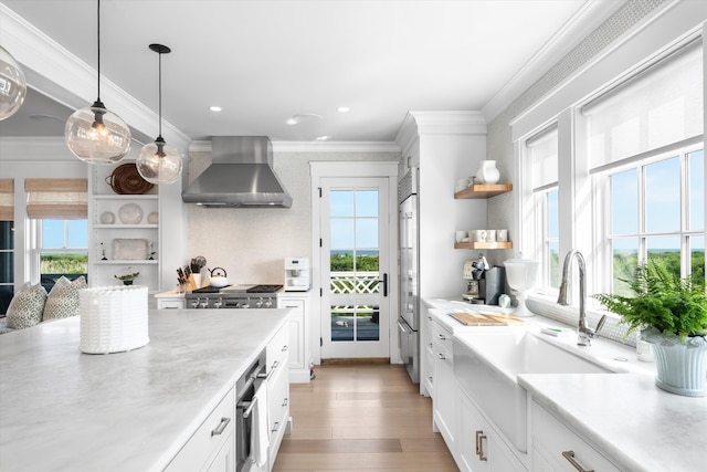 74 38th St, Avalon, NJ 08202 - kitchen with wall chimney range hood, open shelves, healthy amount of natural light, light countertops, and crown molding