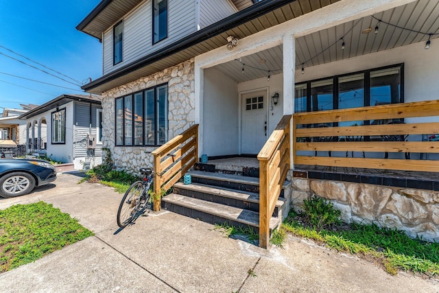 view of exterior entry with covered porch