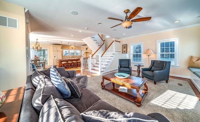 living room with ornamental molding, wood-type flooring, and plenty of natural light