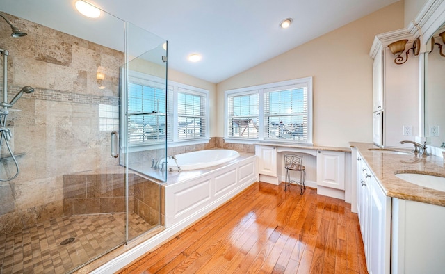 bathroom with vaulted ceiling, hardwood / wood-style floors, vanity, and plus walk in shower