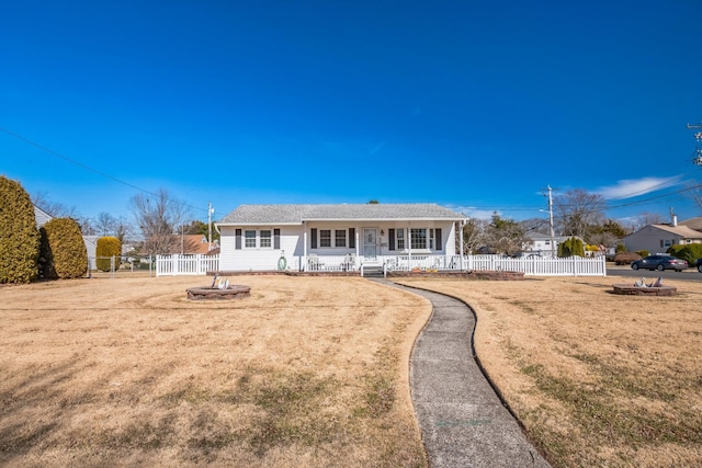 view of front of house featuring a porch, fence, and a front lawn