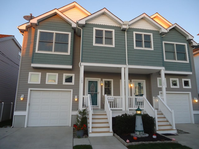 view of front of house featuring a porch and a garage