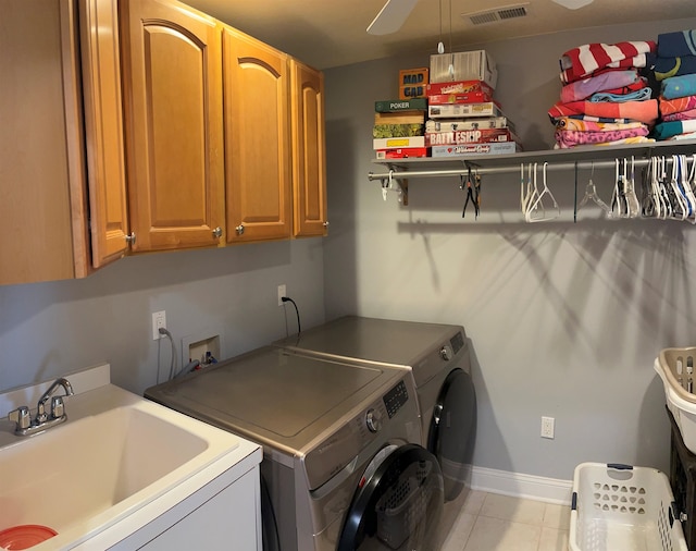 washroom with sink, cabinets, and independent washer and dryer