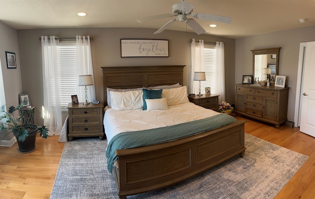 bedroom featuring multiple windows, ceiling fan, and light wood-type flooring