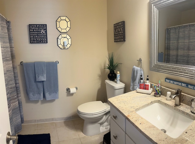 bathroom featuring tile patterned flooring, vanity, and toilet