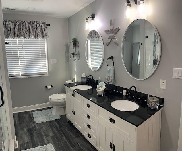 bathroom featuring hardwood / wood-style floors, vanity, and toilet