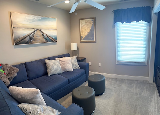 living room with ceiling fan and carpet