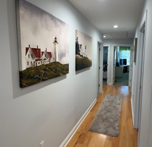 hallway with light hardwood / wood-style floors