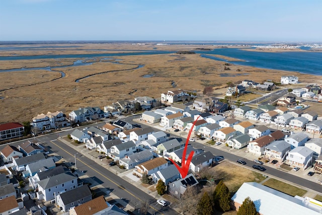 drone / aerial view featuring a water view and a residential view