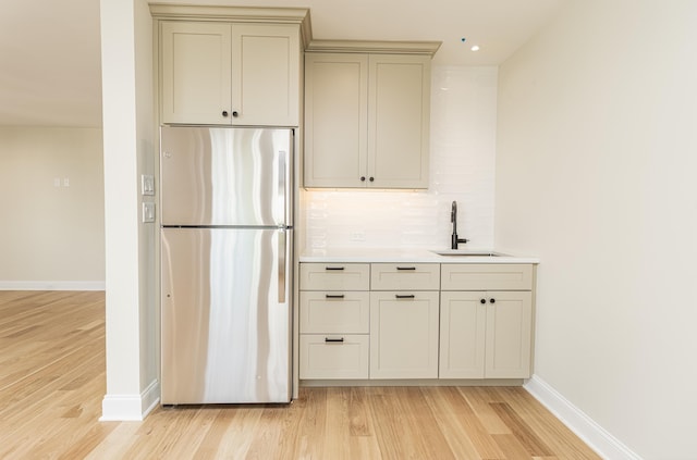 146 22nd St, Avalon, NJ 08202 - kitchen with freestanding refrigerator, light wood finished floors, tasteful backsplash, light countertops, and gray cabinets