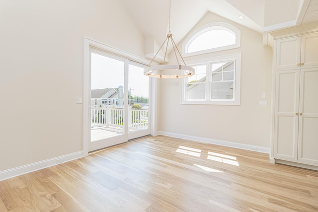 146 22nd St, Avalon, NJ 08202 - unfurnished dining area with a chandelier, plenty of natural light, light wood finished floors, and lofted ceiling