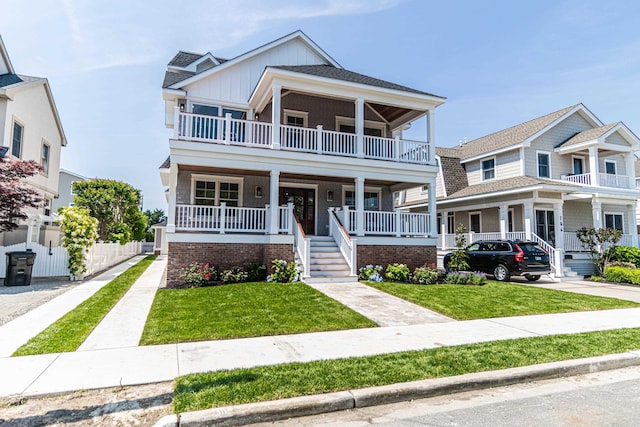 146 22nd St, Avalon, NJ 08202 - multi unit property with board and batten siding, a balcony, a porch, and a front yard